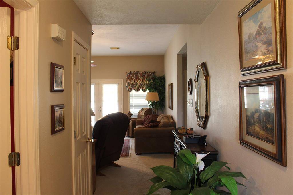 From the front door looking down the entry hall you will be welcomed by the living room with amazing views of the golf course.