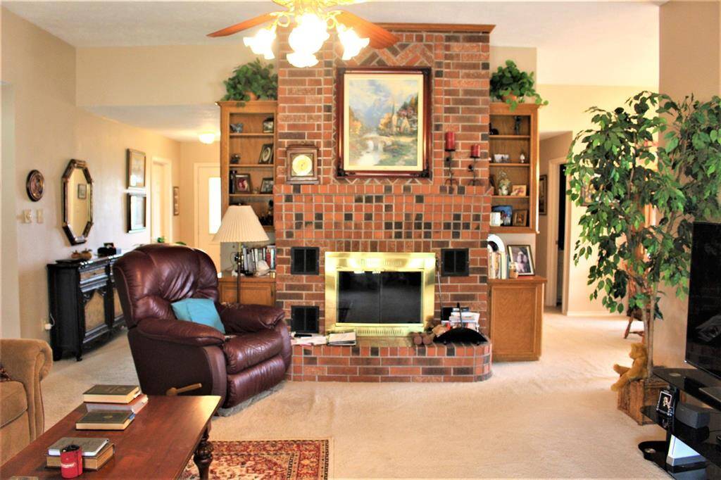 Wood burning fireplace insures this will be a cozy place to snuggle up in the winter. Kitchen is located just to the right.