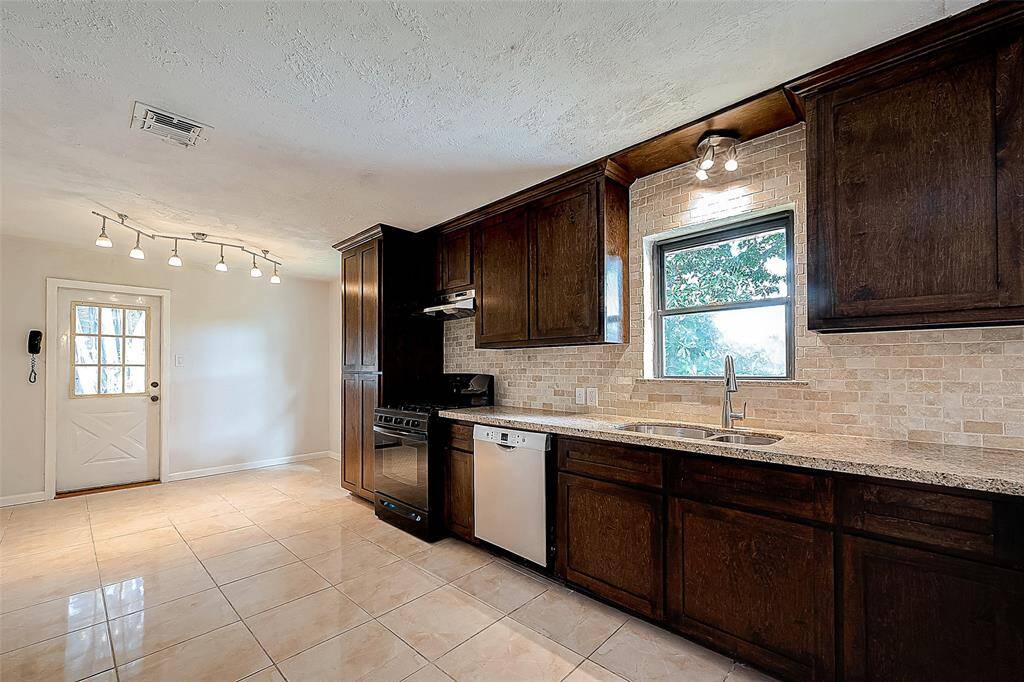 A MASTER CARPENTER CUSTOM BUILT THIS KITCHEN ON SITE! THE RICHLY STAINED WOOD IS ACCENTED BY NEW BACKSPLASH AND GRANITE COUNTERS.