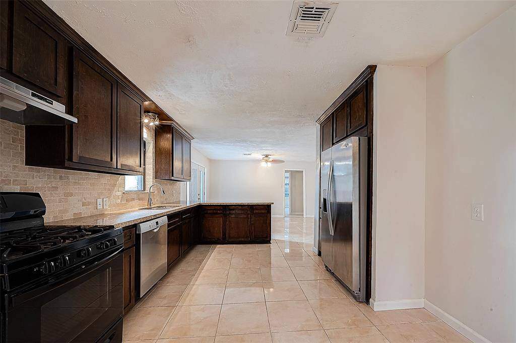 PLENTY OF COUNTER SPACE AND STORAGE! TAKE NOTE OF THE UPGRADED GAS RANGE AND SS DISHWASHER.