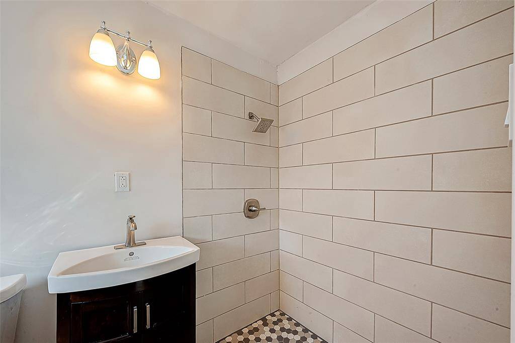 THE PRIMARY ENSUITE HAS BEEN COMPLETELY RENOVATED WITH SINK/VANITY, TILE SHOWER, UPDATED FAUCETS AND LIGHTING.