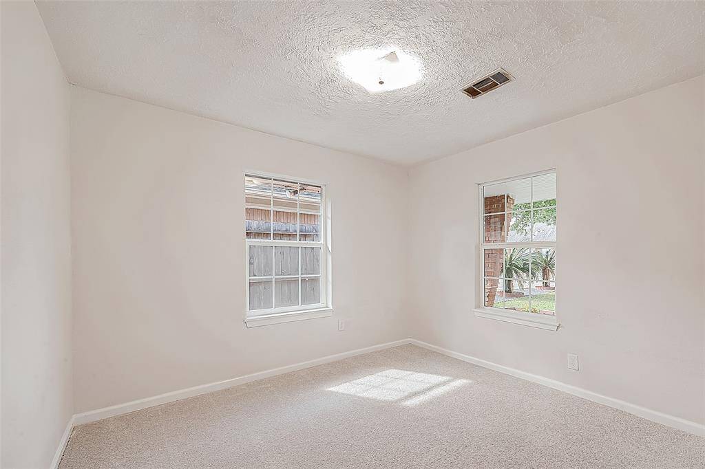BEDROOM 2 IS LIGHT AND BRIGHT WITH TWO WINDOWS AND FEATURES A LARGE CLOSET.