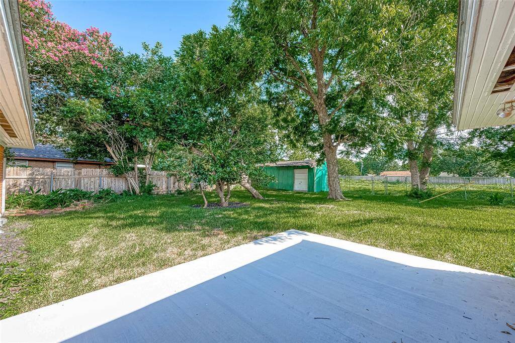 MATURE TREES DOT THE SPACIOUS BACKYARD. THE STORAGE SHED STAYS WITH THE HOME. NO BACK NEIGHBORS!