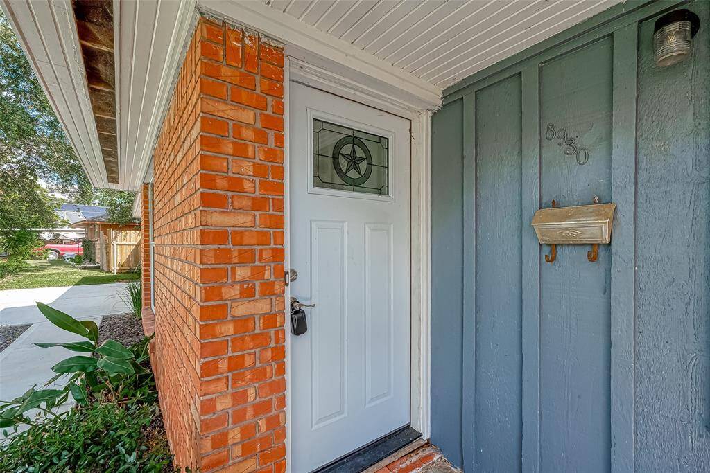 AN UPGRADED FRONT DOOR BECKONS YOU INSIDE.