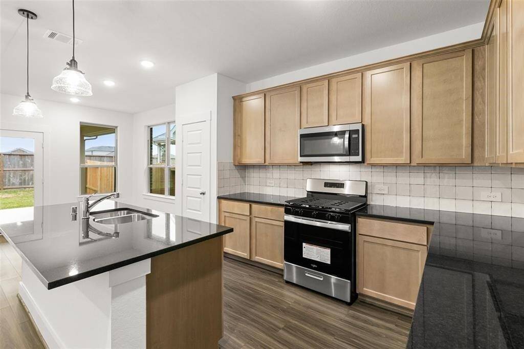Sleek Quartz Countertops and Ceramic Tile Backsplash