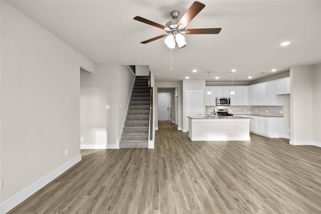 High Ceilings and Luxury Vinyl Plank Flooring Throughout Main Living Areas