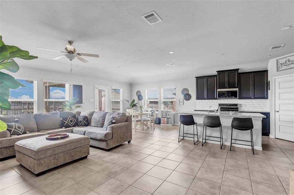 Living room, kitchen, and breakfast area.