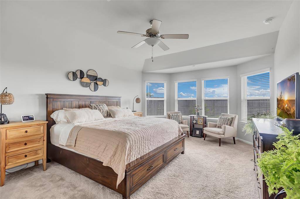 Primary bedroom with bay windows.
