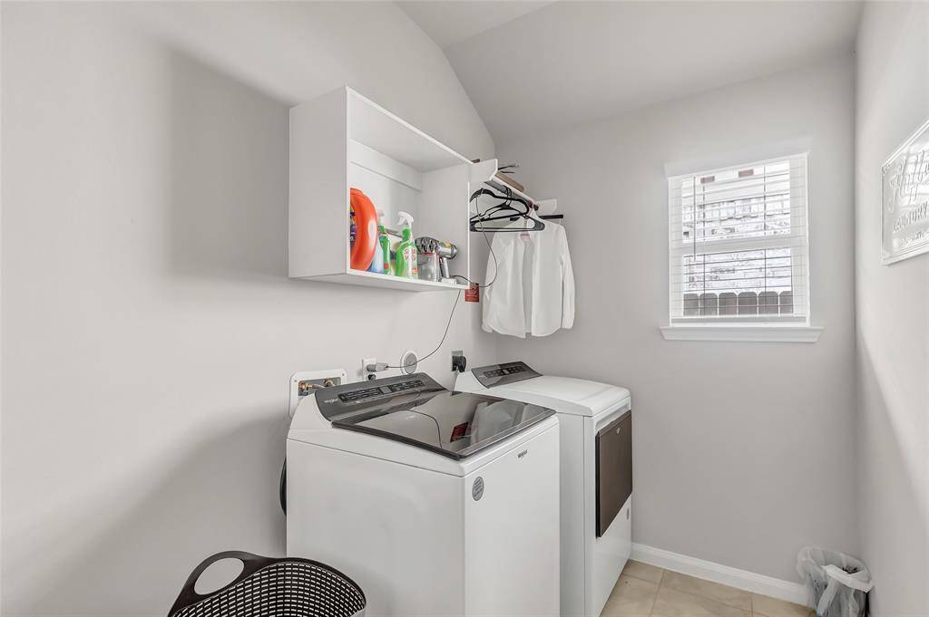 Laundry room in house. Room for a second refrigerator or utility sink.