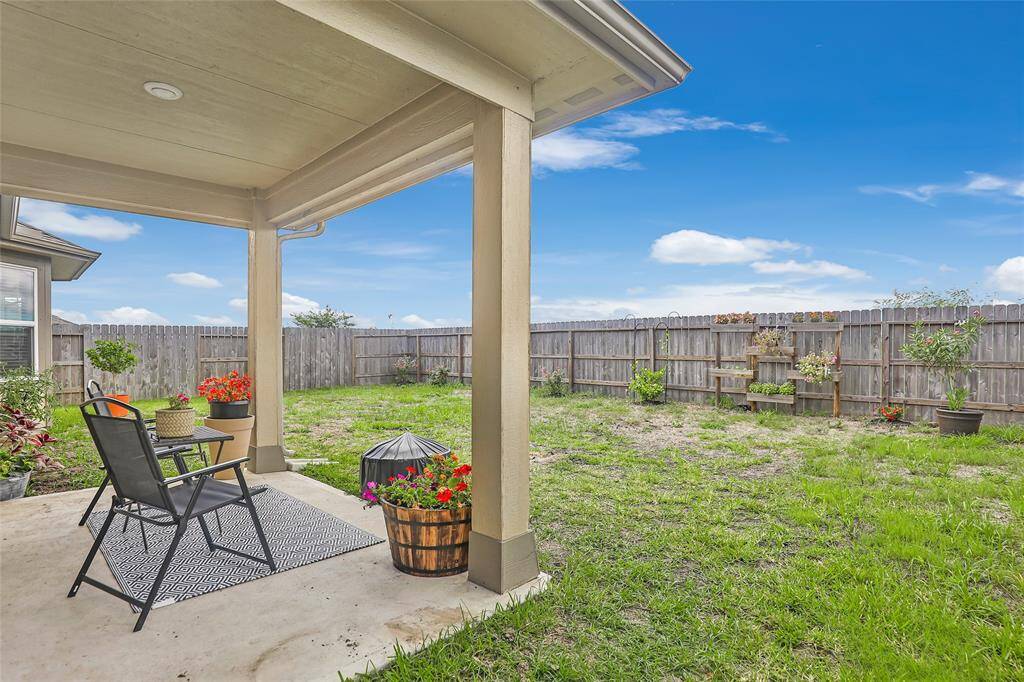 The backyard features a covered patio with no back neighbors!