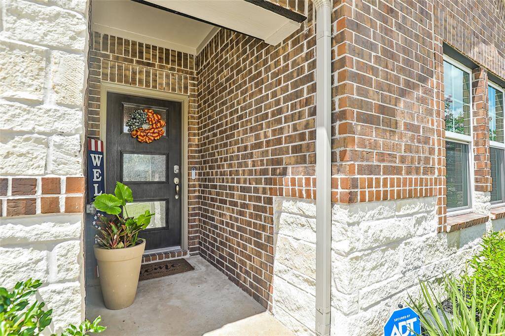 Upgraded elevation includes stone and custom front door.