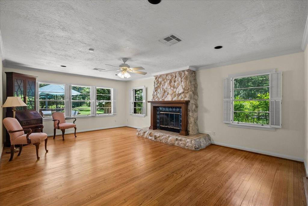 Elevate your gatherings in this formal living room, basking in the glow of natural sunlight. It's the perfect setting to host guests, fostering meaningful conversations and fostering fellowship, away from the hustle of the family room.