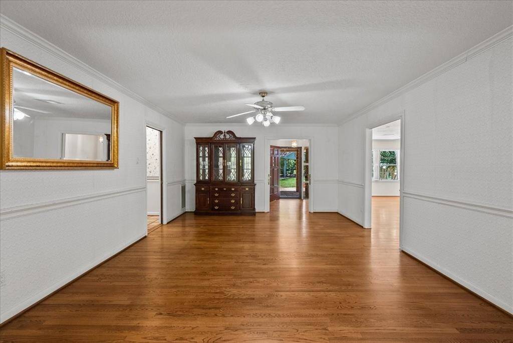 This elegant formal dining room stands poised to accommodate a grand dining table, ready to host gatherings of 8, 10, or even more with grace and style.
