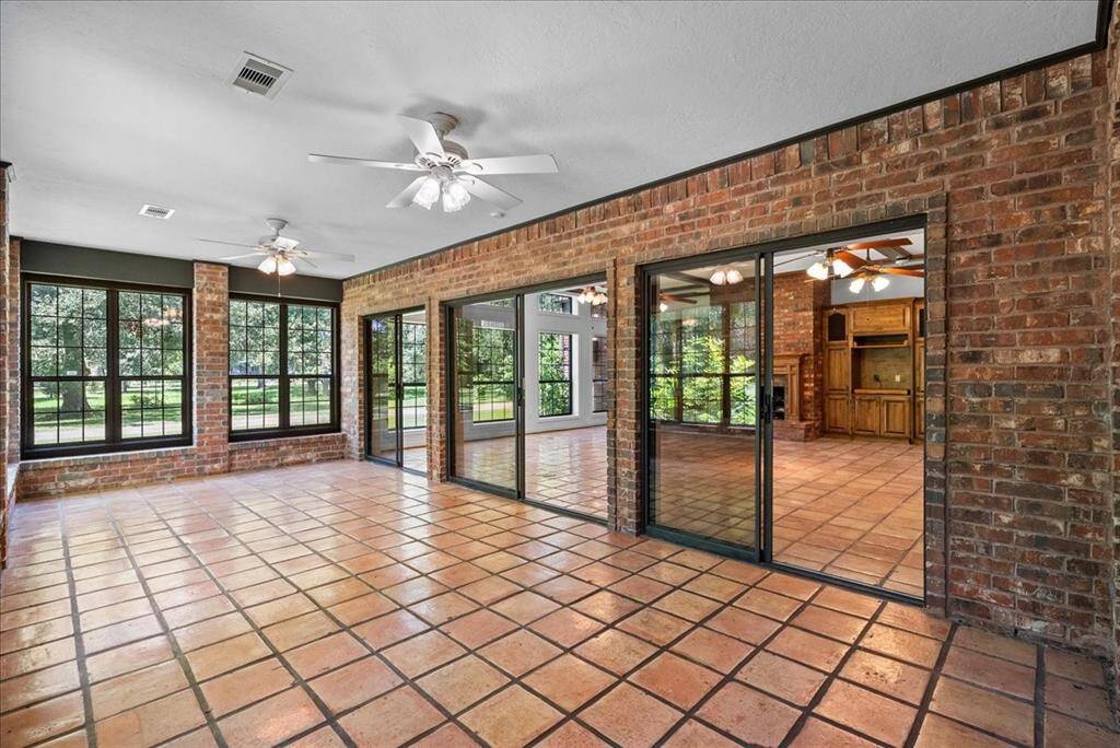 Bask in the warmth of sunlight streaming through the abundant windows encircling this spacious sunroom, seamlessly connecting to the family room—an ideal setting for hosting gatherings and entertaining loved ones.