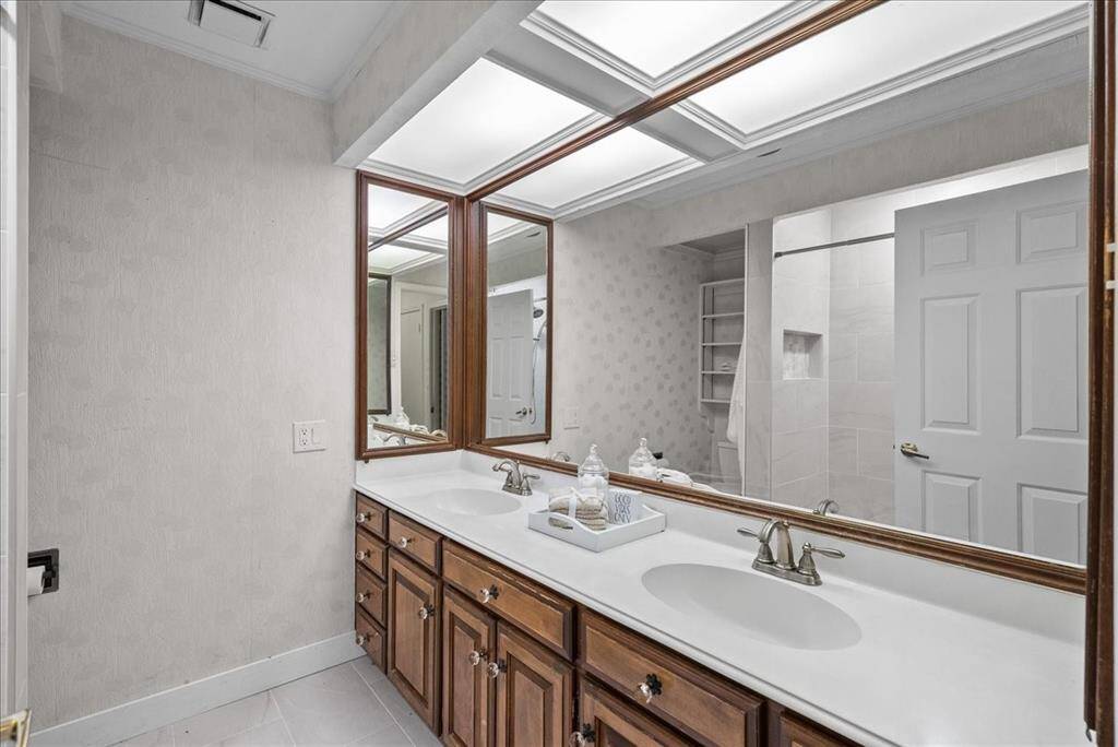 Discover convenience throughout the first floor with a full secondary bathroom, complemented by an additional full bath nestled within the laundry room, and a welcoming half-bath for guests in the foyer.