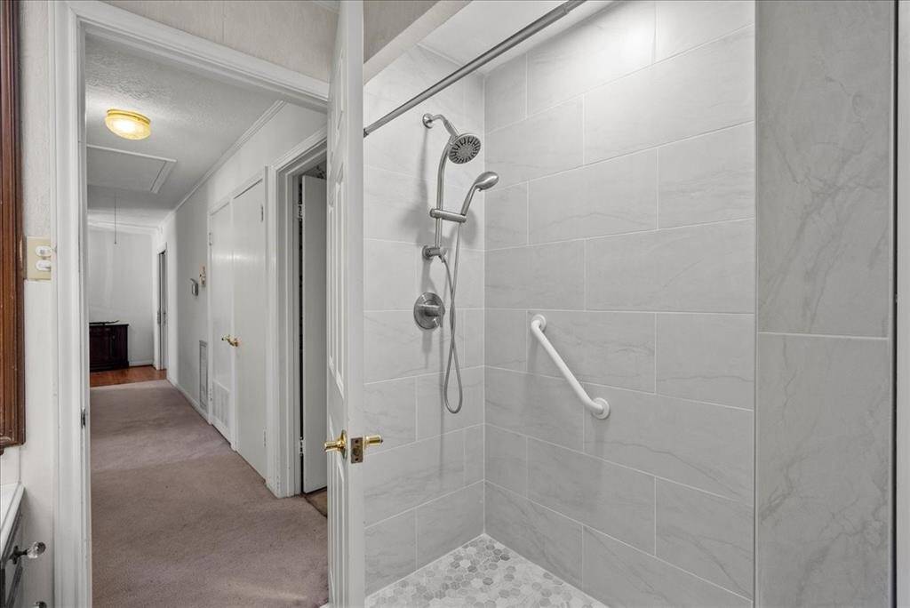 Find relaxation in the conveniently accessible walk-in shower, situated downstairs within the full bathroom.