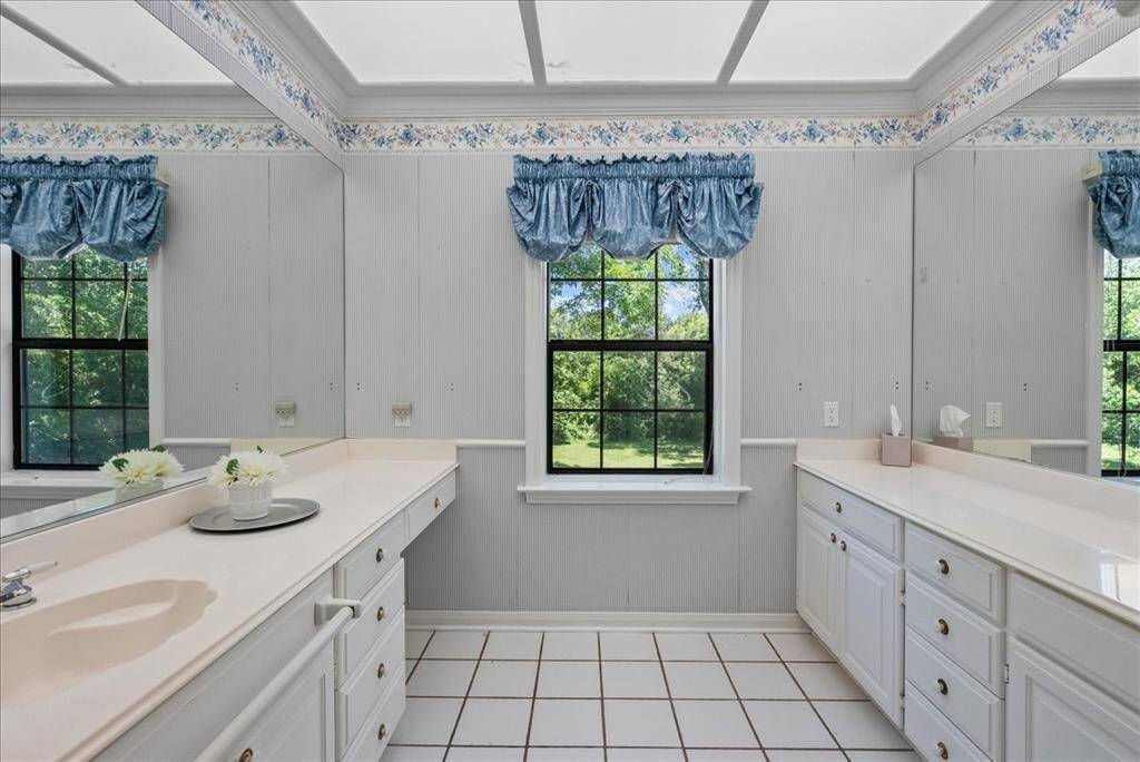 The primary bathroom boasts ample vanity space, ensuring convenience and comfort for your daily routine.