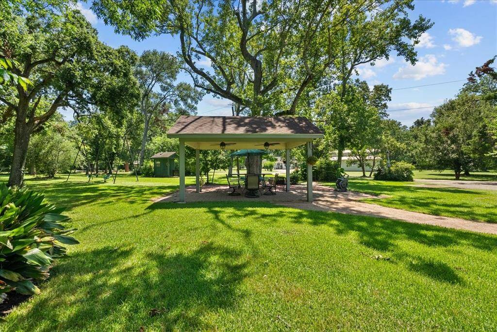 Discover your tranquil casita nestled beneath the trees, where a covered oasis awaits. Perfect for alfresco dining or simply unwinding while enjoying the sights and sounds of nature, it's a serene retreat for birdwatching and squirrel-spotting alike.