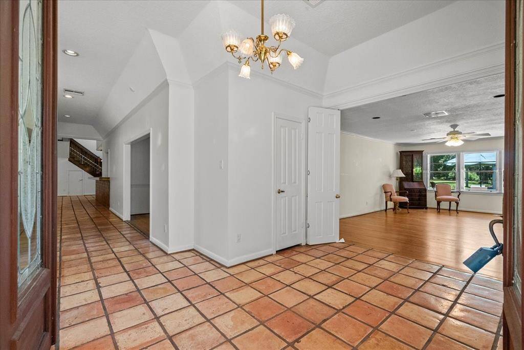 "Welcome to grandeur: Step through double doors into an expansive foyer, where elegance meets space."