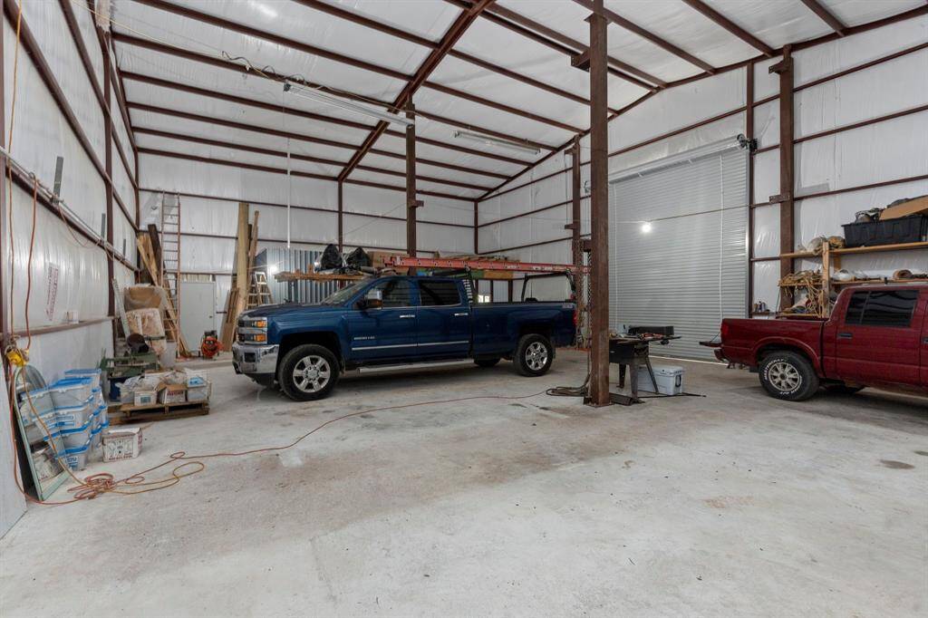The Shop Ceilings are 20-Foot-High Ceilings!  The Shop is about 60 Feet by 40 Feet!  Providing about 2,400 square feet of space. Both the ceilings and walls are insulated with fiberglass.