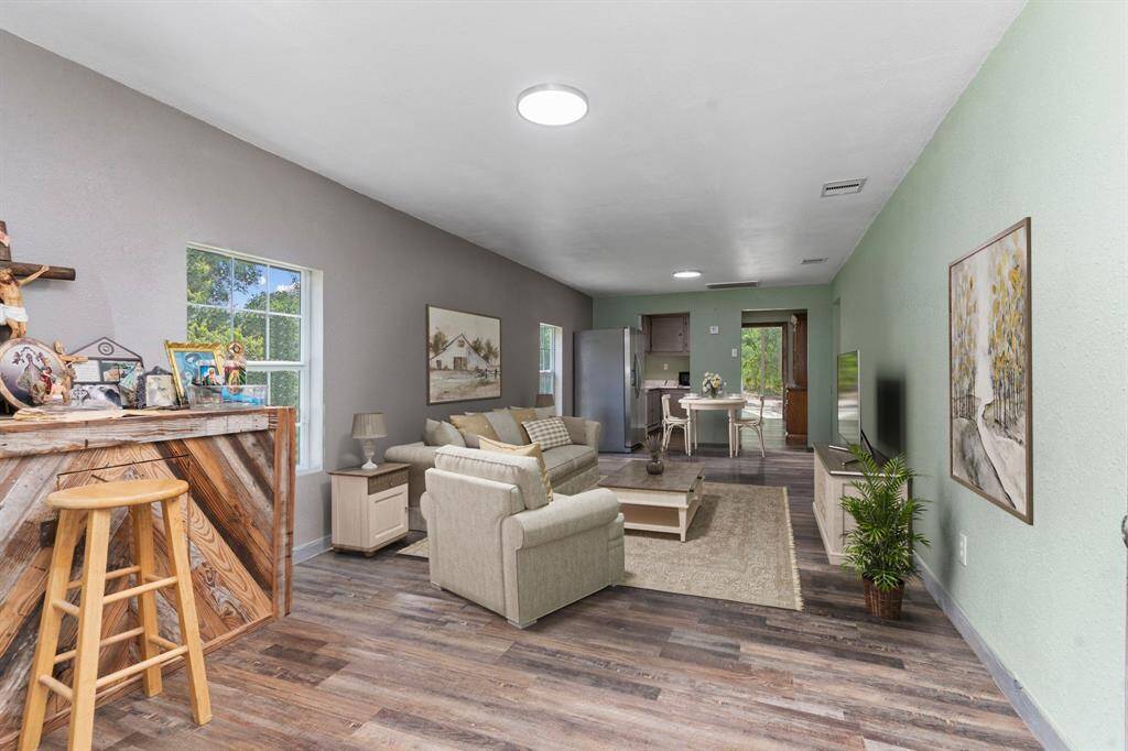 **This photo is Virtually Staged** Family Area with Carefree vinyl Plank like wood floors!
