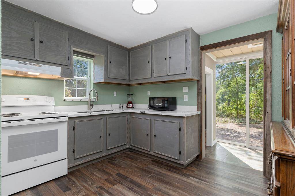 Kitchen has Beautiful Quartz Countertops!  Wall of Window looking out to the trees!