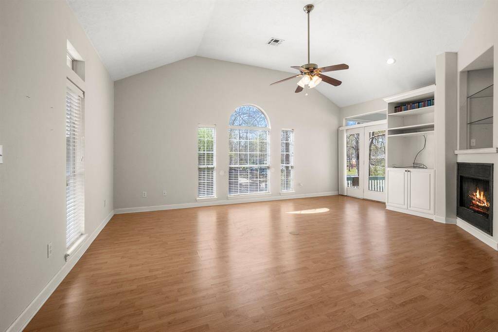 Living Room has Built-in Entertainment Center and lighted china shelves.