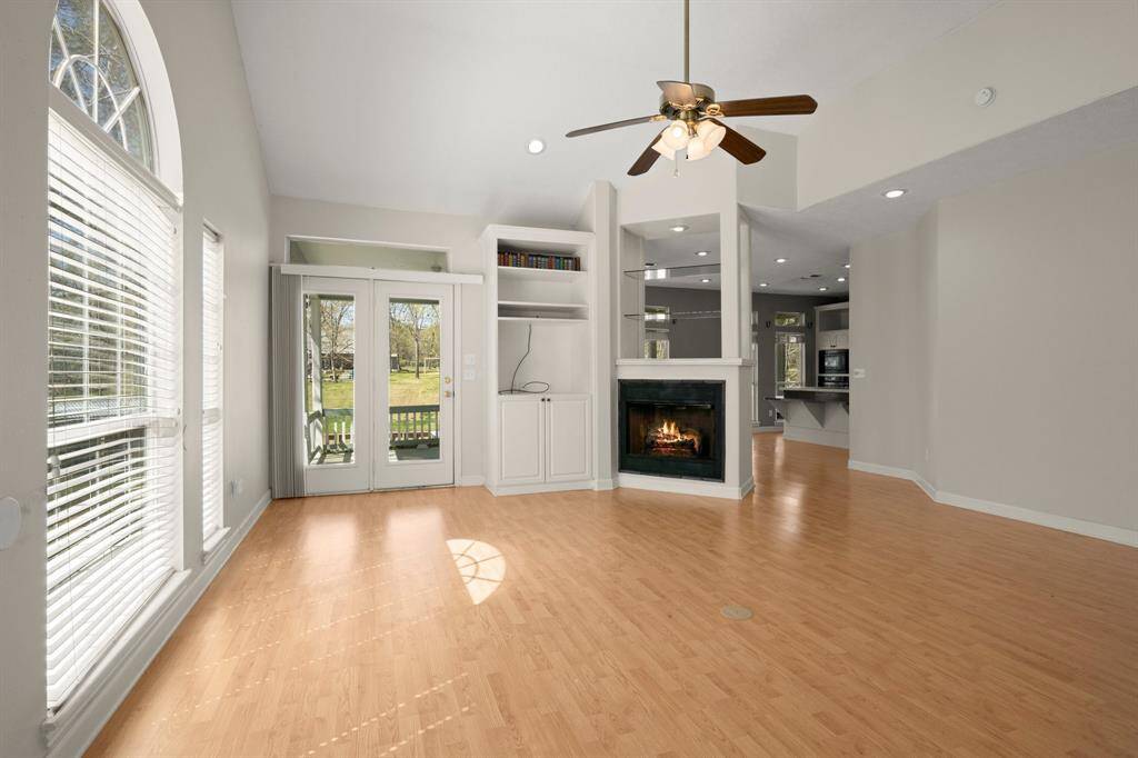 Cozy firplace , high ceilings, and lots of light with this open floor plan  that seamlessly connects to the dining/kitchen area.