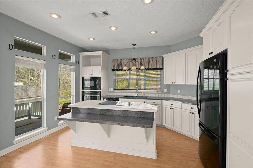 The Kitchen has builtl-in double ovens, Island range top, pantry, and Lots of Windows.