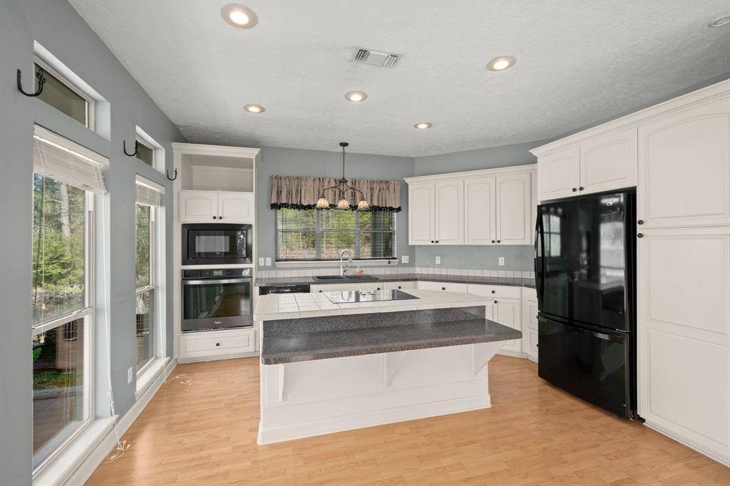 The custom kitchen has lots of counter space, built-in refrigerator, and a roomy pantry.