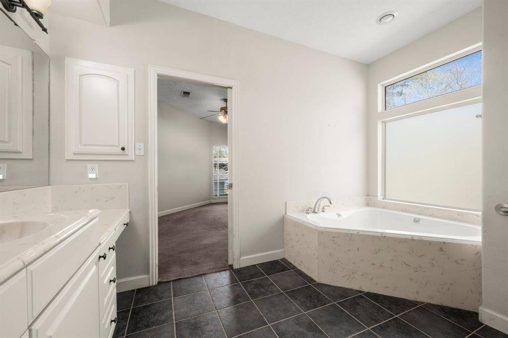 Primary Bath is spacious and has a jetted garden tub.
