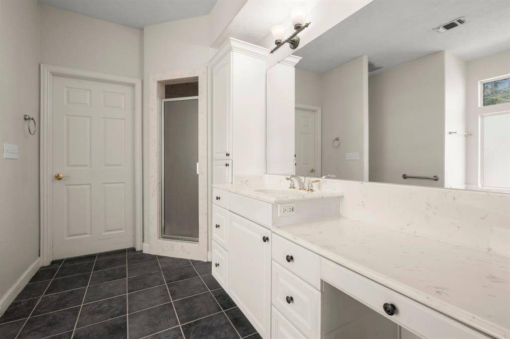 Separate Show and Built-in Vanity in Primary Bath.