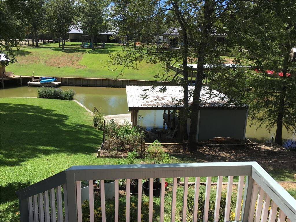Open deck and Covered Porch overlook the Double boat house with storage area.