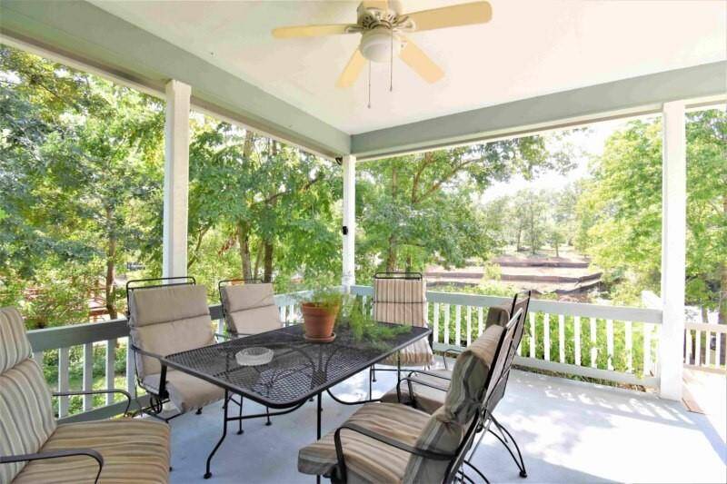 Expansive outdoor space with a large covered wrap-around porch and a deck provide the perfect setting for enjoying gatherings and alfresco dining.