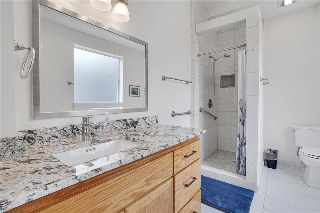 Full bath in bedroom #1. All bathrooms are porcelain tile.
