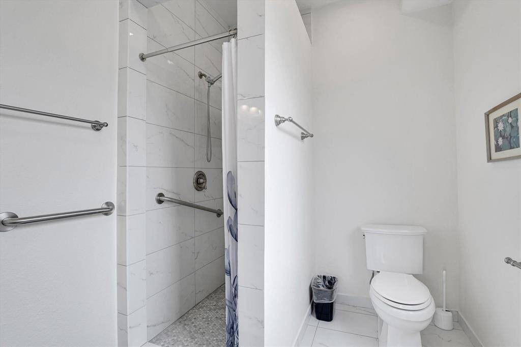 Bedroom #1 with en-suite full bath. All  walk-in showers are tiled to the ceiling.