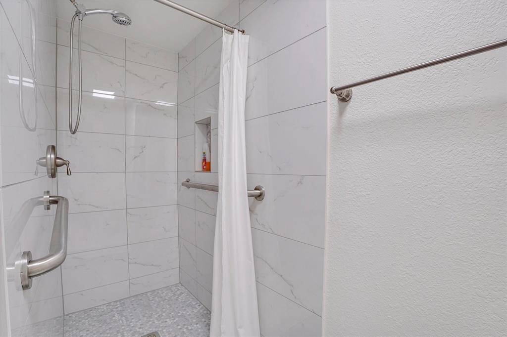Upstairs common bath walk-in shower.