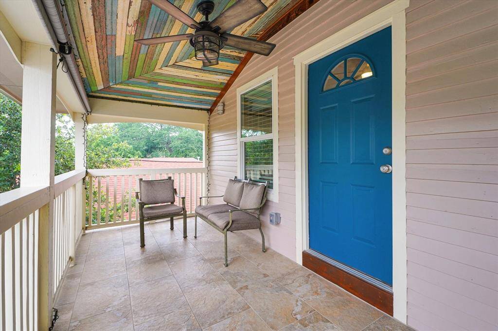 2nd floor front porch has 2 access doors. This blue door is bedroom #3 and there is also access from bedroom #4.
