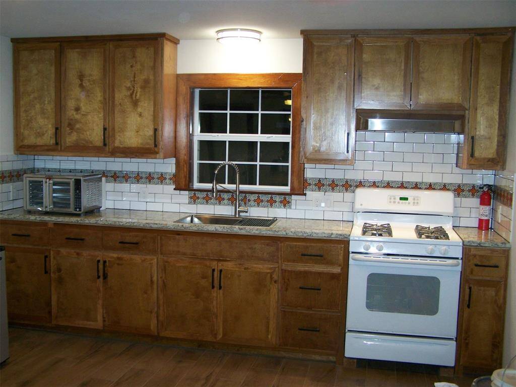 Kitchen in the studio apartment. Porcelain tile flooring.