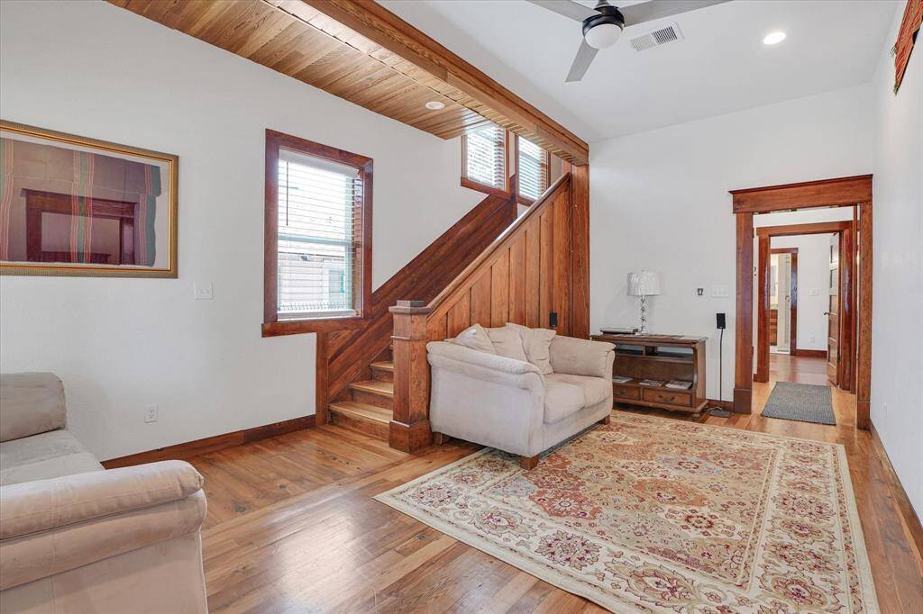 Living room with mostly red pine flooring.
