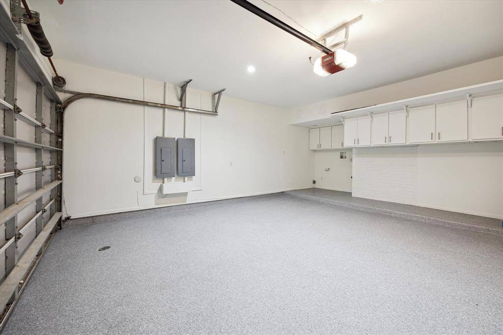 Garage with new epoxy floor with cabinets and laundry area