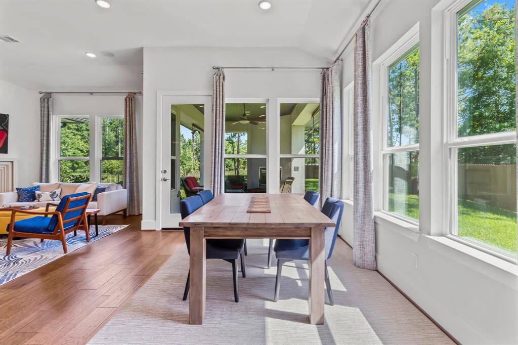 breakfast and living areas offer picturesque views of the patio and private garden