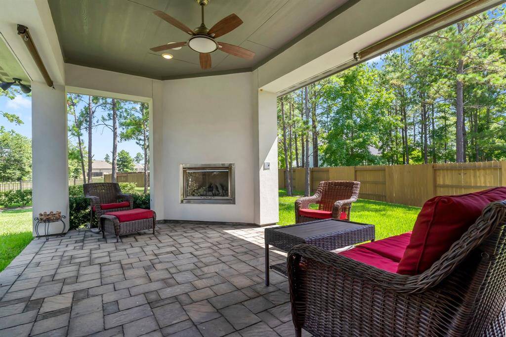 Large covered back patio with gas fireplace