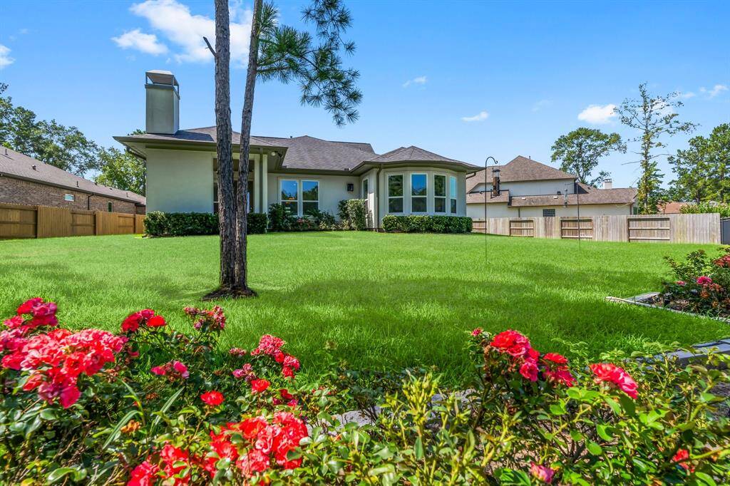 Rear view of home with beatiful flowerbeds