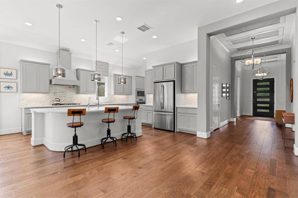 Hallway seamlessly connects to large family living area