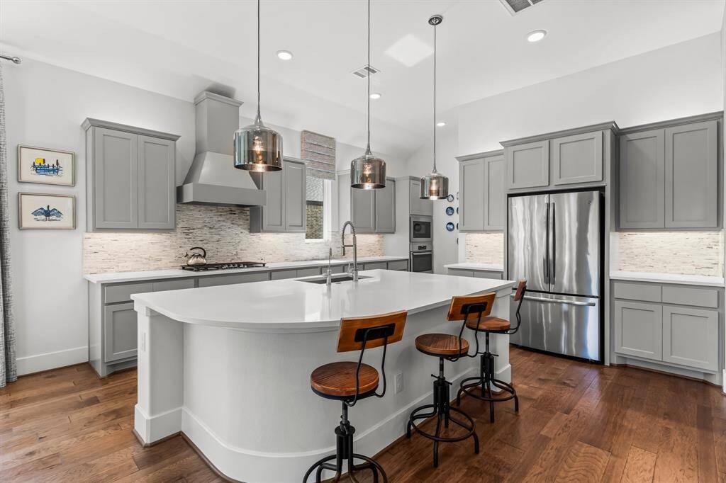 The Kitchen in this home is truly stunning, featuring a cornered island that adds both functionality and elegance