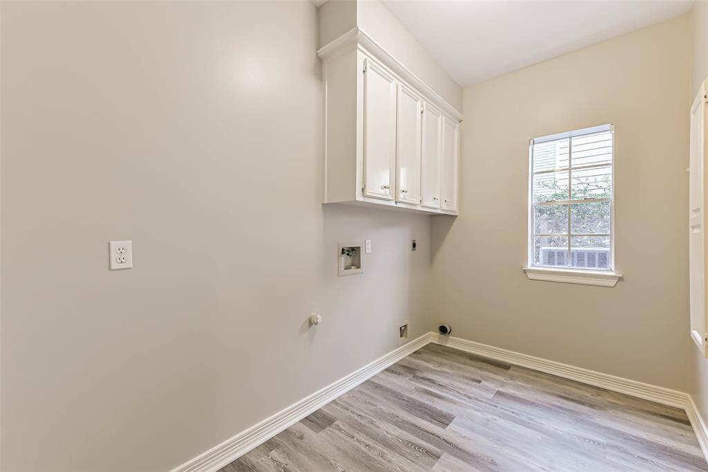 laundry room with built in ironing board and laundry chute