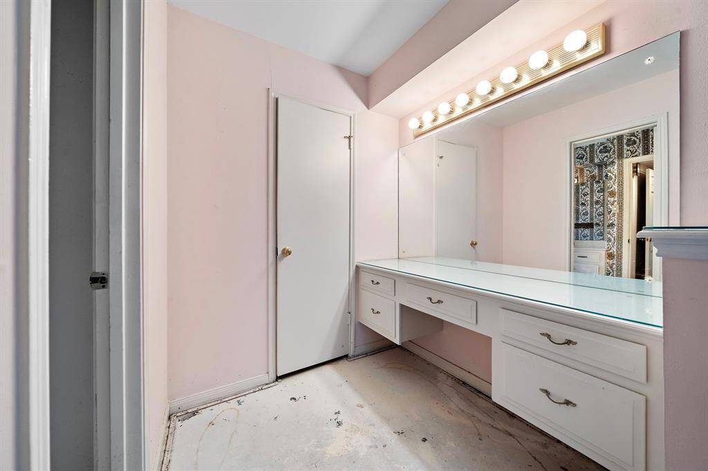 The primary bedroom's ensuite bathroom provides a designated vanity area.