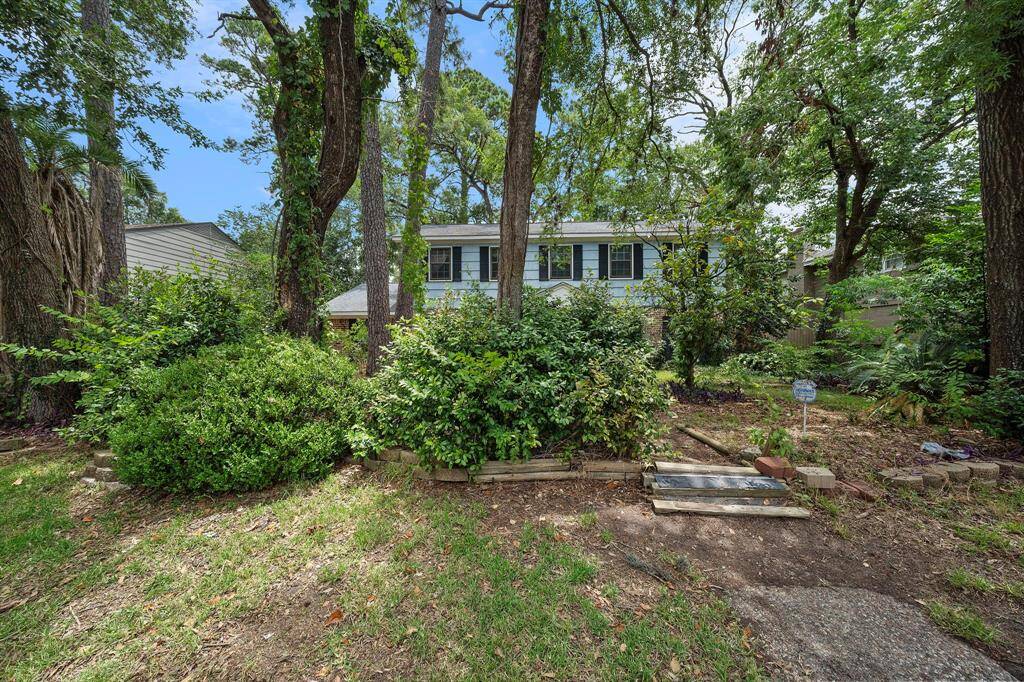 A view of the front of the home nestled in trees.