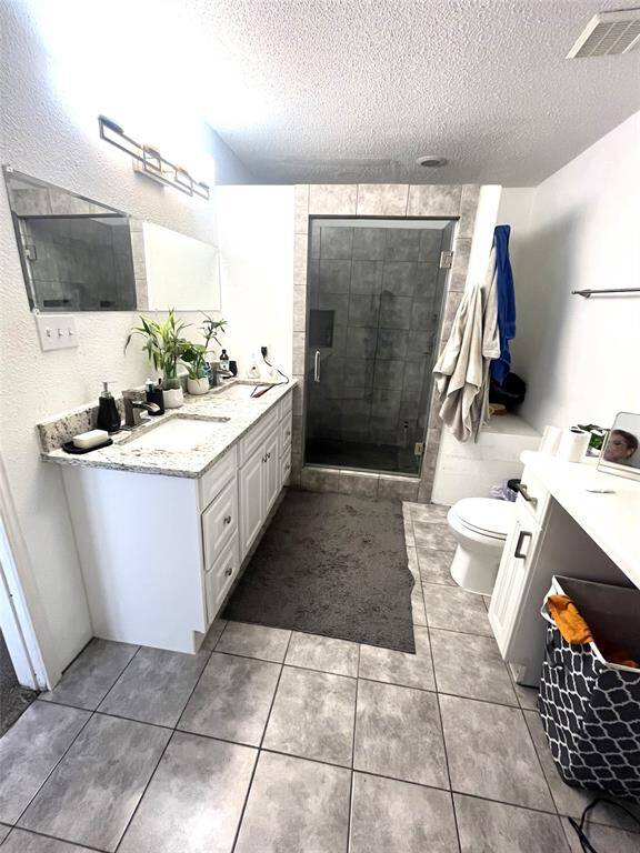 Updated shower in Primary Bathroom with granite double vanities, plus additionaldressing area